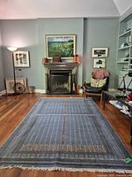 Full view of rug laid flat in room showing overall pattern and scale.