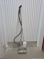 Full view of Jiffy J-2 steamer unit showing base, reservoir, hose and handle