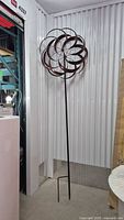 Full view of metal garden wind spinner showing design and height