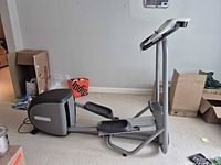 Full side view of the assembled elliptical trainer in a room setting