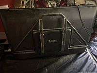Back of TCL TV showing metal wall mount bracket and power cable attached.