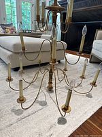 Top-side angle showing wooden central column and curved metal arms with candle lights