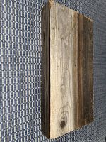 Top and side view of the reclaimed barn board shelf showing wood grain, texture, and natural color variations.