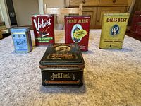 Lot of five vintage tobacco tins: Prince Albert, Velvet, Dill's Best, Leone, Jack Daniel's commemorative tin