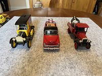 Photo of three collectible toy trucks arranged on a gray surface