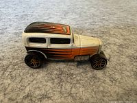 Side view of vintage Hot Wheels die-cast car showing flame paint and detailed wheels