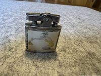 Front side of lighter showing pin-up girl in yellow holding a purse with a kiss mark