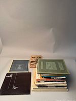 Photo showing a collection of art and design books and catalogues grouped together on a plain background.