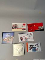 Overview of five commemorative stamp covers with various themes laid out on a surface