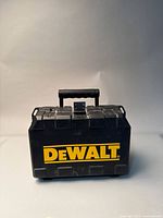 Closed black DeWalt tool case showing the large yellow branding on the front and the carrying handle.