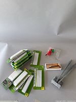 Full view of packs of white plastic plant tags, metal shears box, metal L-shaped plant tags and plastic watering nozzles.