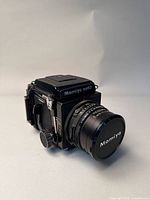 Front three-quarter view of camera with lens attached