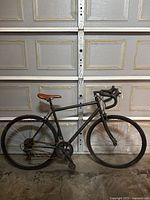 Side view of the medium black bicycle showing overall frame, saddle, and wheels.