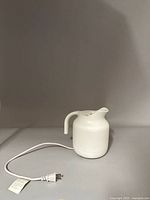 Muji white electric kettle with attached power cord view