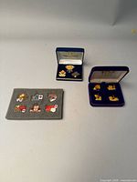 Overview of Toronto Blue Jays commemorative pins, some loose and some in the original display cases.