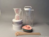 All items together including scale, measuring jug, pitchers, egg holders, and wooden utensil.