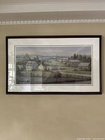 Full view of framed painting showing countryside farm scene with house, barns, and fields under an overcast sky.