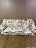 Front view of the modern 3-seater sofa showing patterned fabric upholstery and three seat cushions.