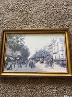 Full view of the framed print showing the entire street scene and frame details.