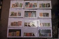 Full view showing all 12 stock cards with mixed early Russian stamps from Imperial and Soviet periods in various colors and conditions.