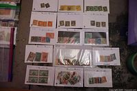 Photo showing fifteen stock cards with multiple early Canadian postage stamps organized by era and series.