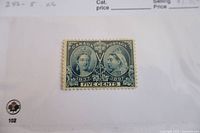 Front of the 1897 Canada 5 cent Queen Victoria Jubilee stamp showing portraits, text and perforations.