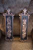 Pair of vintage Syroco wall sconces showing floral and fruit raised relief detail and their overall shape and size.