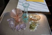 Lot of six glass pieces on metal tray: pink compote, purple cruet, citron swan, blue vase with gold, pink luster ware, small amber dish