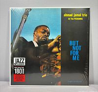 Front of sealed LP showing album art and hype sticker