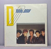 Front album cover with band photo and large D logo