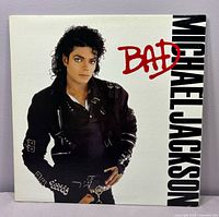 Front cover featuring Michael Jackson image and album title Bad