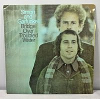 Front album cover showing title and artists, chip on upper right corner