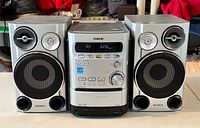 Front view of stereo system showing main unit flanked by both speakers