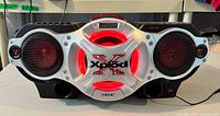 Front view of Sony Xplod CFD-G770CPK showing speakers, central CD door with red illumination and Xplod logo