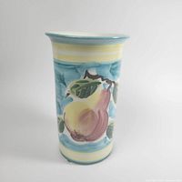 Front view of vase showing fruit motif and striped pattern.