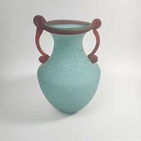 Front and side views showing the 9-inch frosted turquoise body with red scroll handles, textured surface, and open mouth.