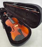 Violin inside original soft case with bow secured inside case.