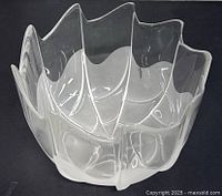 Angled view showing the bowl's scalloped rim with alternating frosted and clear glass panels.