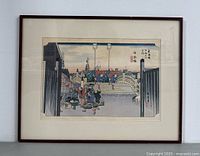 Full view of framed woodblock print on wall