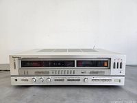 Front panel view powered on showing tuning display at 91.15 and LED meters