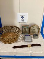 Full lot view showing all items: basket, wristwatch, clock, pillbox, Sony Walkman, and prayer book