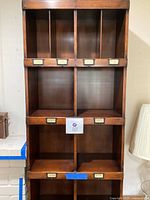 Front view of bookshelf showing twelve compartments and bottom drawer