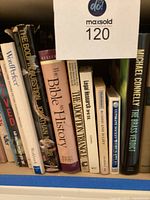 Photo of the first set of books including titles such as 'Bible History', 'Legal Research and Writing', and 'The Brass Verdict' by Michael Connelly