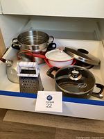 Photo showing entire set including steamer, cheese grater, kettle, enamel pot, and Brilliant Cook soup pot with lid