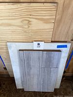Photo showing the stacked plywood, white marble slab, and laminate panel with a blue label showing 34 x 26 for the marble slab dimensions