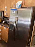 Full view of refrigerator in kitchen setting with two filter boxes on top