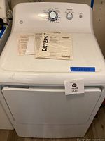 Front view of dryer with instruction manual on top