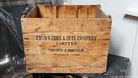 Front view of the wooden crate showing the company name and Canadian origin.