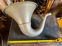 Gramophone horn side view showing full length and curve with measuring tape for size reference