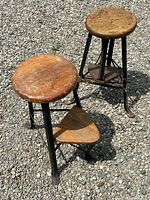 Two stools side by side on gravel surface showing overall appearance